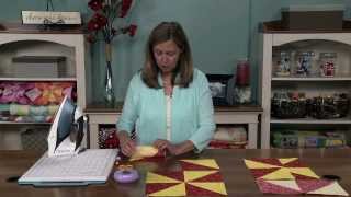 How to Make a Pinwheel Quilt Block  National Quilters Circle [upl. by Aiem557]